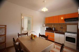 a kitchen with a table with a bowl of fruit on it at Silo Apartment 13 in Šilo