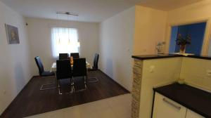 a dining room with a table and chairs in a room at Malinska Apartment 1 in Sveti Anton