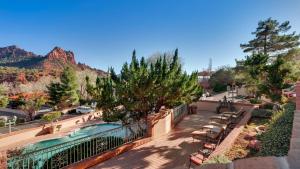 
a large stone building with trees and palm trees at Best Western Plus Arroyo Roble Hotel & Creekside Villas in Sedona
