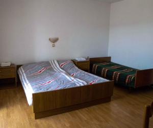 a bedroom with two beds and two night stands at Apartment Lopar 1 in Lopar