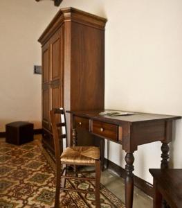 a desk with a chair and a wooden cabinet at La Lampara in Trapani