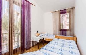 a bedroom with two beds and a table and windows at Apartment in Silo/Insel Krk 13498 in Šilo