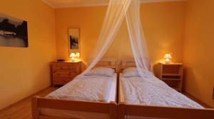 a bedroom with two beds with mosquito nets at Apartment Malinska, Krk 14 in Sveti Vid-Miholjice