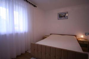 a bedroom with a bed and a window with curtains at Apartment in Silo/Insel Krk 14597 in Šilo