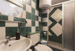 a bathroom with a toilet and a sink at Studio in Crikvenica 5257 in Dramalj