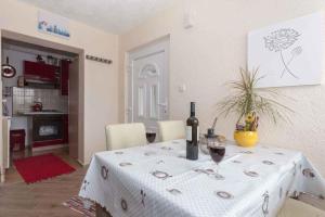 a table with a bottle of wine and two glasses at Studio in Crikvenica 5257 in Dramalj