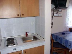 a small kitchen with a sink and a stove at Studio Crikvenica 8 in Dramalj