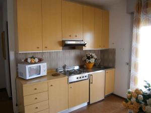 a kitchen with a microwave and a stove top oven at Studio in Bibione 24407 in Bibione