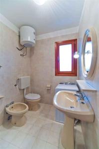 a bathroom with a sink and a toilet and a mirror at Studio in Bibione 24407 in Bibione