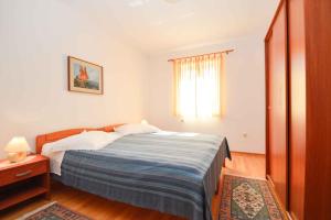 a bedroom with a large bed and a window at Apartment Vinkuran 6 in Vinkuran