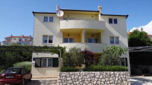 a house with a car parked in front of it at Apartment Okrug Gornji 32 in Trogir