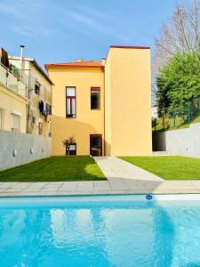 a house with a swimming pool in front of a house at Porto Wine Loft Duplex with swimming pool in Vila Nova de Gaia