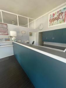 an office with a long counter and a clock on the wall at Allambie Motel in Condobolin