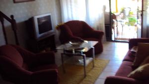a living room with two chairs and a coffee table at Holiday home in Balatonmariafürdo 19321 in Balatonmáriafürdő