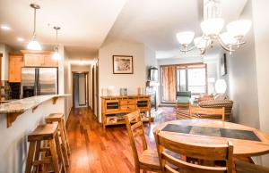 a kitchen and dining room with a table and chairs at Beautiful Peak Vista - 2BR w Stunning Mt Views in Canmore