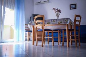 a kitchen with a table and chairs and a table and a table and chairsktop at Apartment Barbat, Rab 1 in Barbat na Rabu
