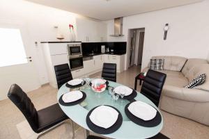 a living room with a dining room table and chairs at Apartment Crikvenica 20 in Crikvenica