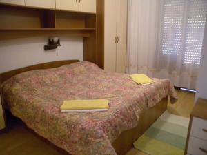 a bedroom with a bed with two towels on it at Apartment Kampor 5 in Kampor