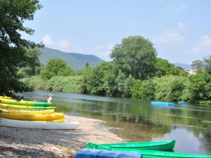 a group of canoes on the shore of a river at Holiday home with pool in Cuxac Cabard s in Cuxac-Cabardès