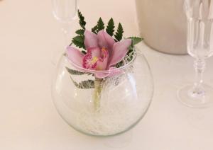 a vase with a pink flower in it on a table at B&B Il Quadrifoglio Tropea in Tropea