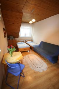 a living room with two beds and a table at Pokoje Klaudia in Darłowo