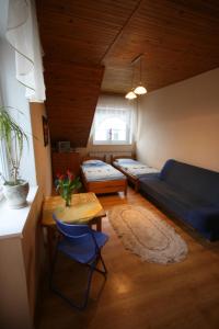 a living room with a blue couch and a table at Pokoje Klaudia in Darłowo