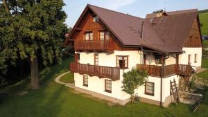 a large white house with a brown roof at Apartment Rokytnice nad Jizerou 6 in Hranice