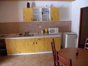 a kitchen with a sink and a table and a microwave at Apartments in Desna - Isergebirge 1786 in Šumburk nad Desnou +11 photos