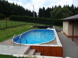 a large swimming pool in a yard with at Holiday home in Svahova/Erzgebirge 1640 in Svahová