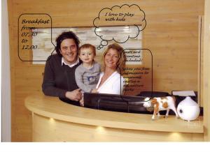 a picture of a man and a woman with a child at Relais Fior di Bosco in Folgaria