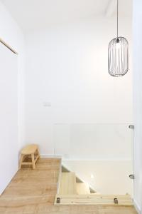 a room with a table and a pendant light at Casa da Praça in Bragança