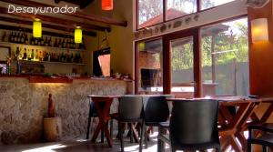 a bar with tables and chairs in a restaurant at Complejo Casa Caracolnegro in Mar de Cobo +20 photos