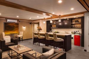 a living room with a bar and a kitchen at Fathoms Hotel & Marina in Port Washington