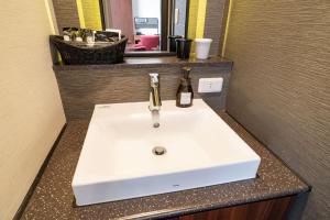 a bathroom sink with a bottle of wine on it at Goi Grand Hotel in Ichihara +73 photos