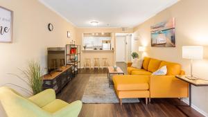 a living room with a yellow couch and chairs at Integrity - Real Hollywood Experience in Los Angeles