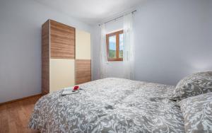 Postel nebo postele na pokoji v ubytování Apartments Drenje