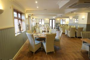 a dining room with a table and chairs at The Elm Tree Inn in Wisbech