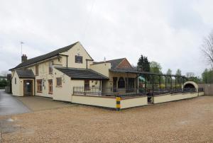a building with a train station in front of it at The Elm Tree Inn in Wisbech