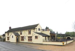 a building with a playground in front of it at The Elm Tree Inn in Wisbech