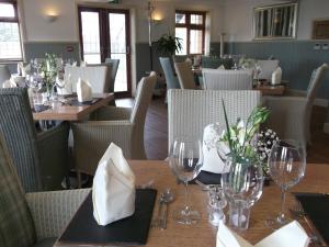 a dining room with wooden tables and chairs and tablesktop at The Elm Tree Inn in Wisbech