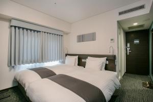 a large white bed in a room with a window at Mars Garden Hotel Hakata in Fukuoka +44 photos