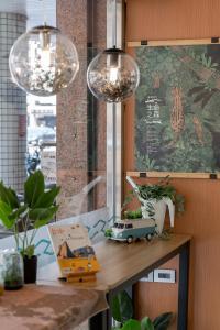 a table with pendant lights and a toy car on it at 二川行旅 - HiRiver Hotel in Taichung