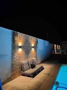 a couch sitting in front of a stone wall at Las Eras 2 in Herencia