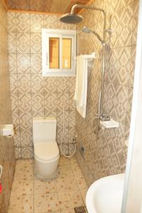 a bathroom with a toilet and a sink at RESIDENCE AMAR in Douala +44 photos