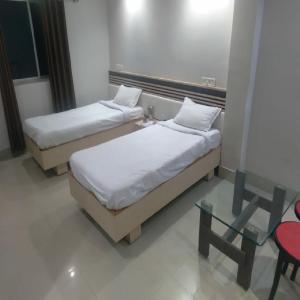 מיטה או מיטות בחדר ב-HOTEL ARYAN INTERNATIONAL