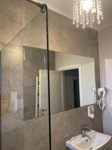 a bathroom with a sink and a mirror at COCHET BOUTIQUE in Târgu Jiu +57 photos
