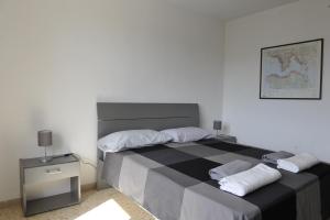 a bedroom with a large bed with two pillows at Casa Marconi in Tuoro sul Trasimeno