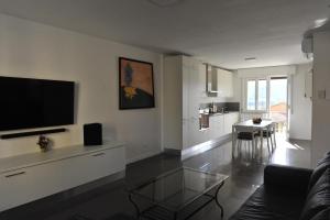 a living room with a flat screen tv on the wall at Casa Marconi in Tuoro sul Trasimeno