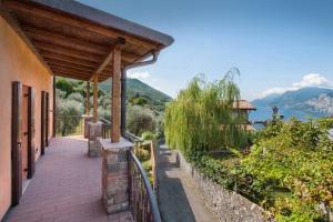 a porch of a house with a view of the water at Casale San Michele in Malcesine