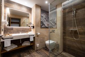 a bathroom with a sink and a shower at Hotel Belmont in Sinaia